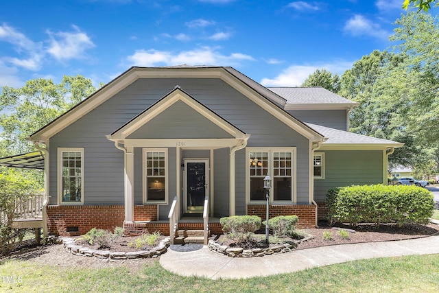 view of front of property featuring covered porch and brick siding