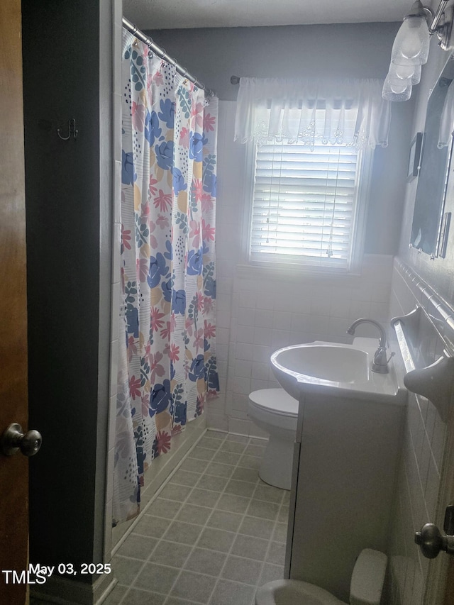 66 Epsom Rocky Ford Rd, Henderson, NC 27537 - full bath with a shower with curtain, vanity, toilet, tile walls, and tile patterned flooring