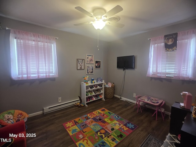 66 Epsom Rocky Ford Rd, Henderson, NC 27537 - playroom featuring a baseboard heating unit, a ceiling fan, wood finished floors, and baseboards