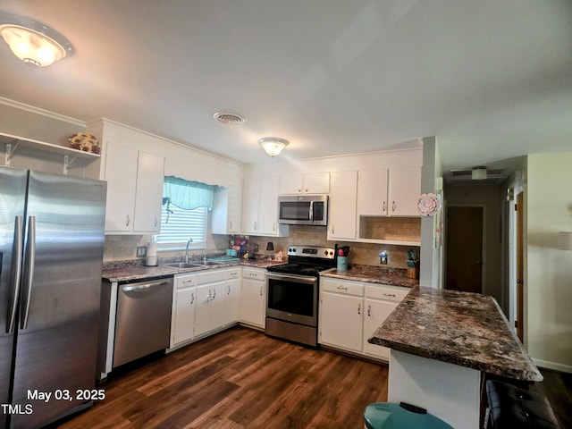66 Epsom Rocky Ford Rd, Henderson, NC 27537 - kitchen featuring stainless steel appliances, open shelves, a sink, a peninsula, and white cabinets