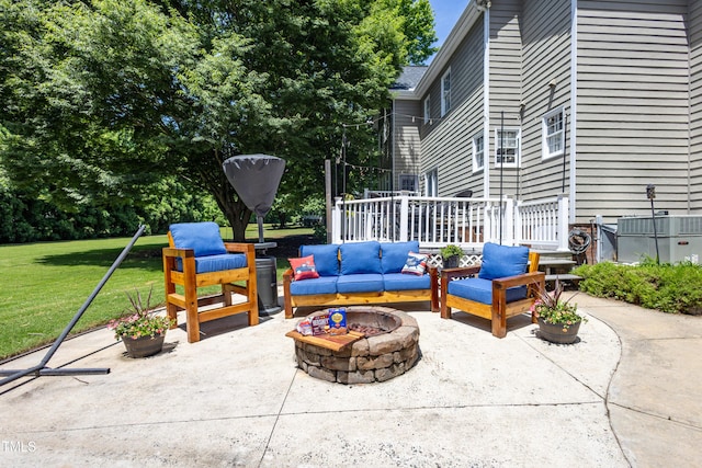 view of patio with an outdoor living space with a fire pit and cooling unit
