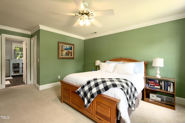 bedroom with ornamental molding, light carpet, baseboards, and ceiling fan