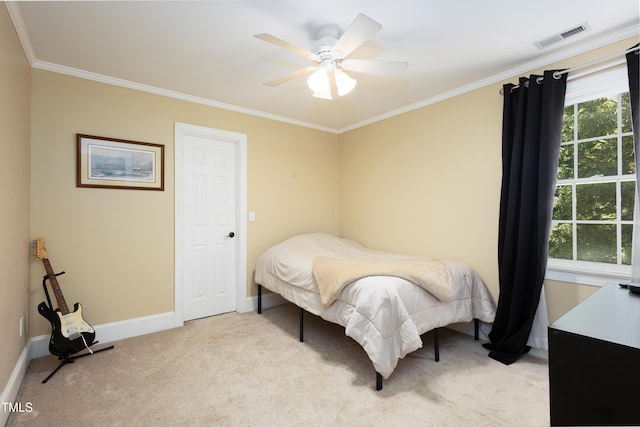 bedroom featuring crown molding, light carpet, baseboards, and a ceiling fan