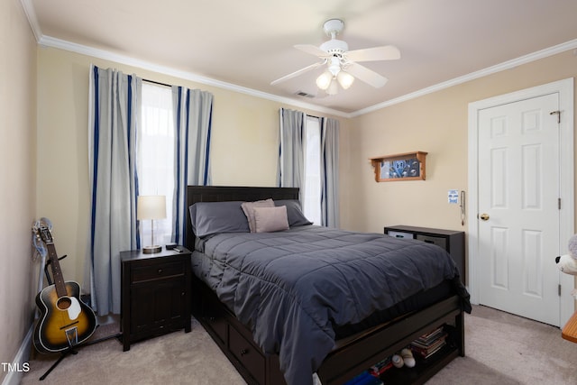 bedroom with light colored carpet, ornamental molding, and a ceiling fan