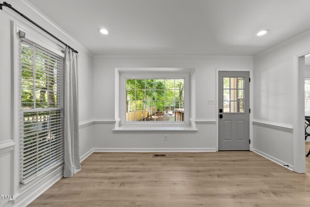 doorway to outside with crown molding, light wood-type flooring, baseboards, and recessed lighting