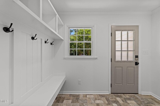mudroom with baseboards, ornamental molding, and stone finish floors