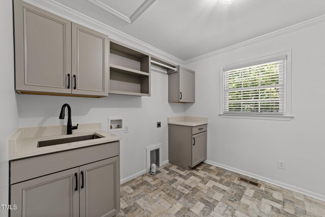 laundry area featuring electric dryer hookup, hookup for a washing machine, ornamental molding, baseboards, and cabinet space