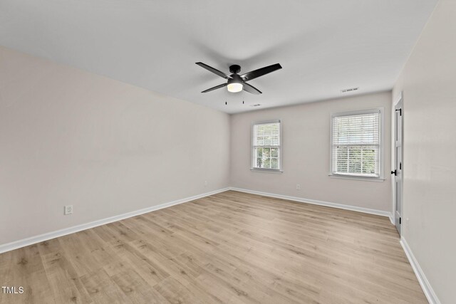 empty room with light wood-style flooring, baseboards, and ceiling fan