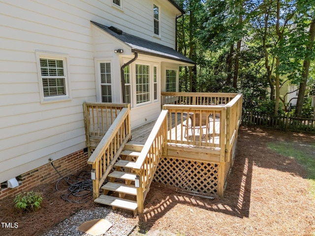 wooden terrace featuring fence and stairway