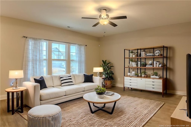 537 Kivett Ct, Fayetteville, NC 28312 - living room with baseboards, ceiling fan, and light wood-style flooring