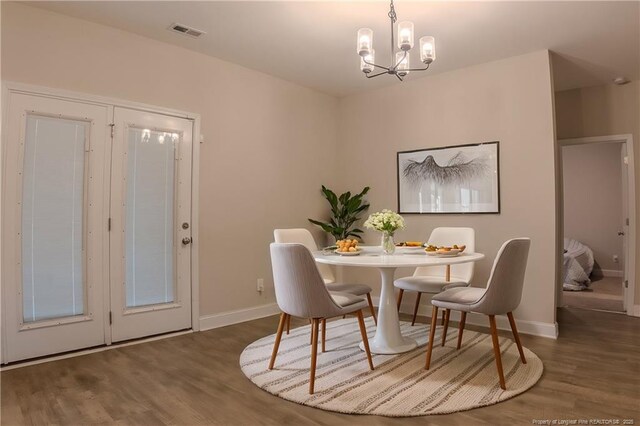 537 Kivett Ct, Fayetteville, NC 28312 - dining space featuring baseboards, a chandelier, wood finished floors, and visible vents