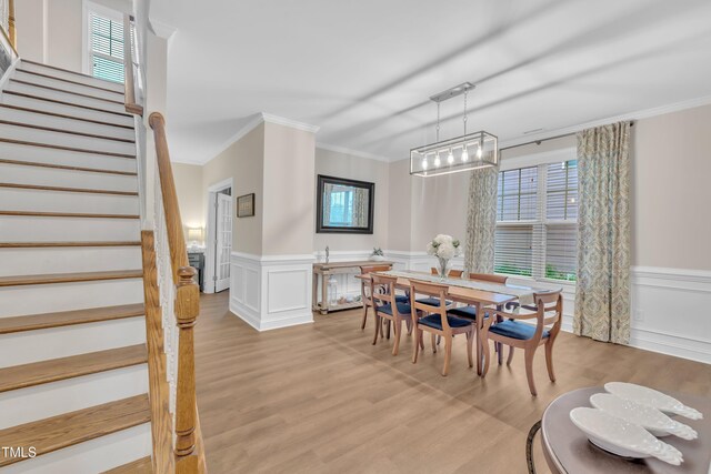1920 Bright Kannon Way, Wendell, NC 27591 - dining area with crown molding, stairway, light wood finished floors, a wainscoted wall, and healthy amount of natural light