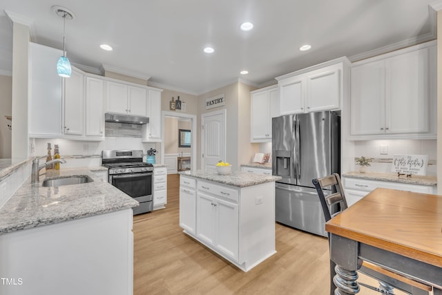 1920 Bright Kannon Way, Wendell, NC 27591 - kitchen featuring stainless steel appliances, a sink, ornamental molding, under cabinet range hood, and white cabinetry