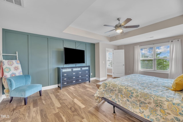 1920 Bright Kannon Way, Wendell, NC 27591 - bedroom with a tray ceiling, light wood-type flooring, baseboards, and a ceiling fan