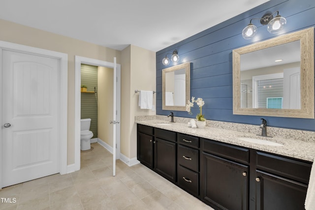 1920 Bright Kannon Way, Wendell, NC 27591 - bathroom featuring double vanity, toilet, tile patterned floors, wood walls, and baseboards