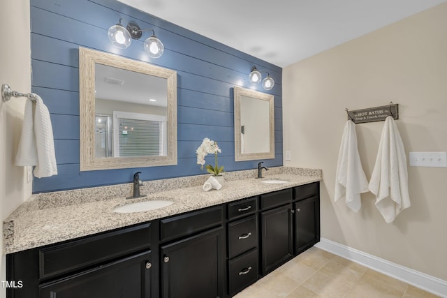 1920 Bright Kannon Way, Wendell, NC 27591 - full bathroom with double vanity, baseboards, wood walls, and tile patterned flooring