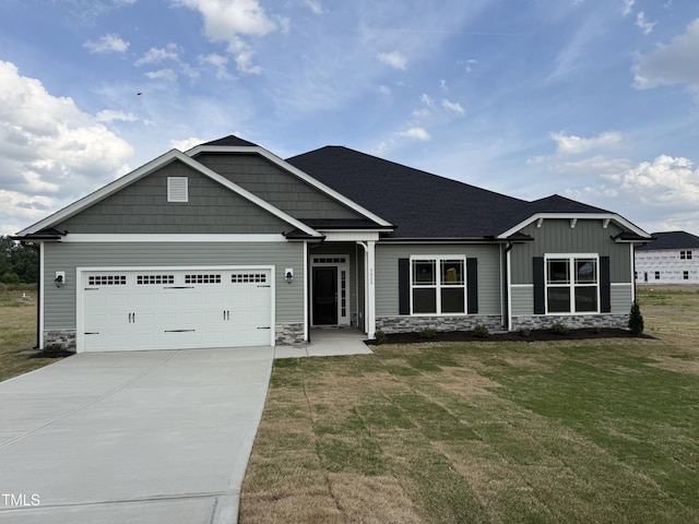 craftsman-style home with a garage, a front yard, stone siding, board and batten siding, and driveway