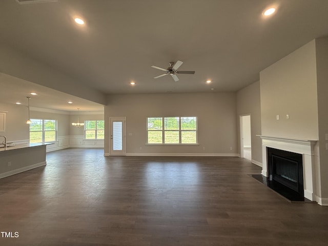 unfurnished living room featuring a ceiling fan, a fireplace with flush hearth, recessed lighting, and dark wood-style floors