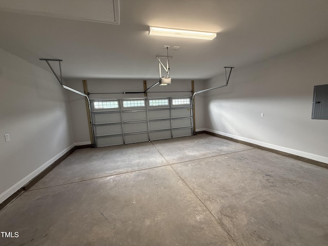garage featuring baseboards, a garage door opener, and electric panel