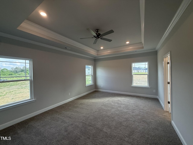 unfurnished room with crown molding, a raised ceiling, carpet floors, and baseboards