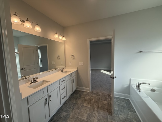 full bath with double vanity, a sink, baseboards, and a bath