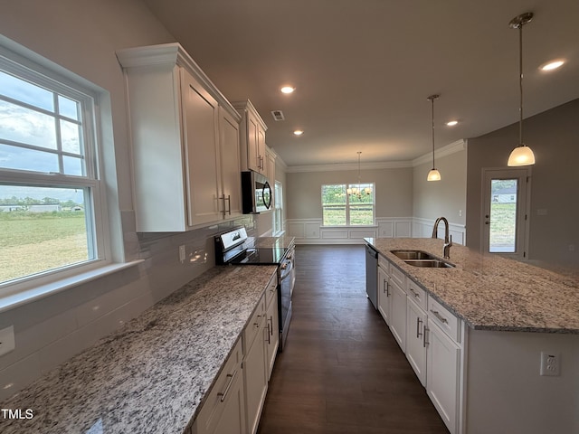 kitchen featuring an inviting chandelier, ornamental molding, white cabinetry, a sink, and appliances with stainless steel finishes