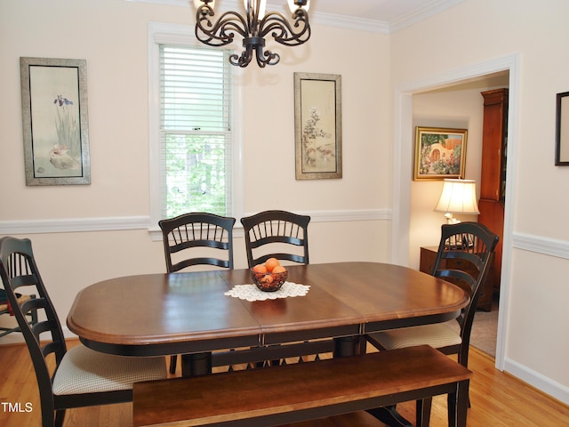 1707 Falls Church Rd, Raleigh, NC 27609 - dining area with a chandelier, light wood finished floors, healthy amount of natural light, ornamental molding, and baseboards