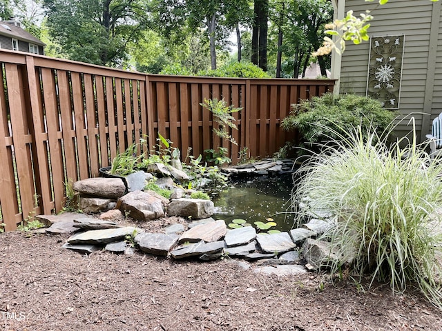 1707 Falls Church Rd, Raleigh, NC 27609 - view of yard with fence and a garden pond