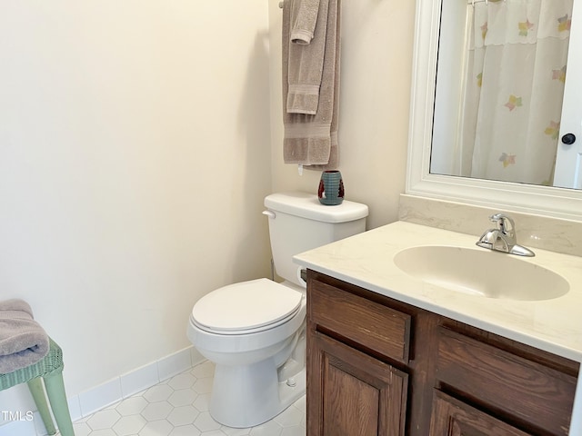 1707 Falls Church Rd, Raleigh, NC 27609 - full bath featuring toilet, tile patterned flooring, vanity, and a shower with shower curtain