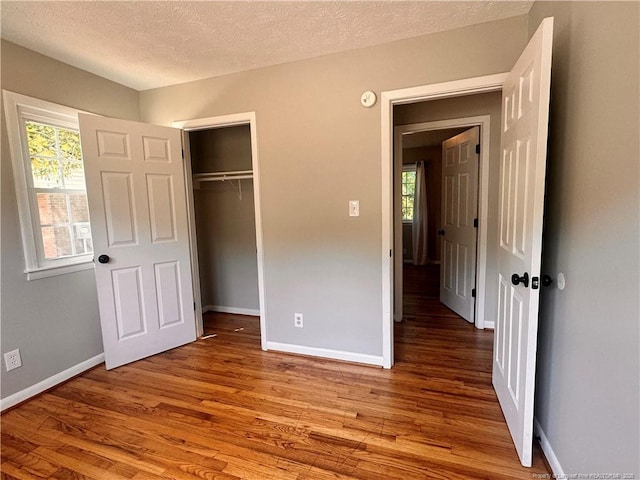1512 Grandview Dr, Fayetteville, NC 28314 - unfurnished bedroom with wood finished floors, baseboards, a textured ceiling, and a closet