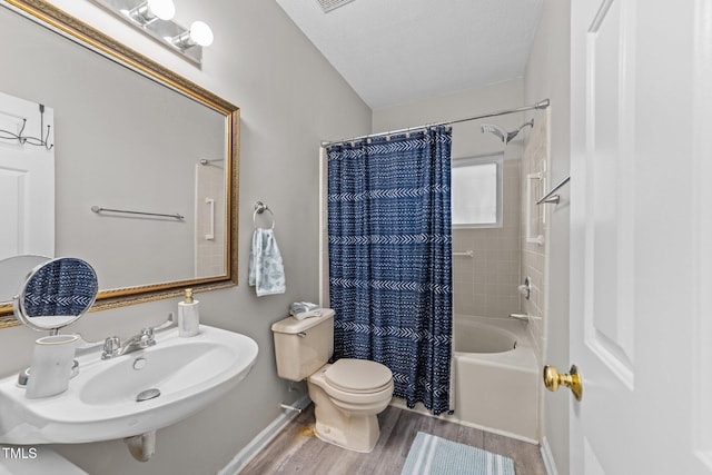 full bathroom with wood finished floors, toilet, a sink, and shower / bath combo with shower curtain