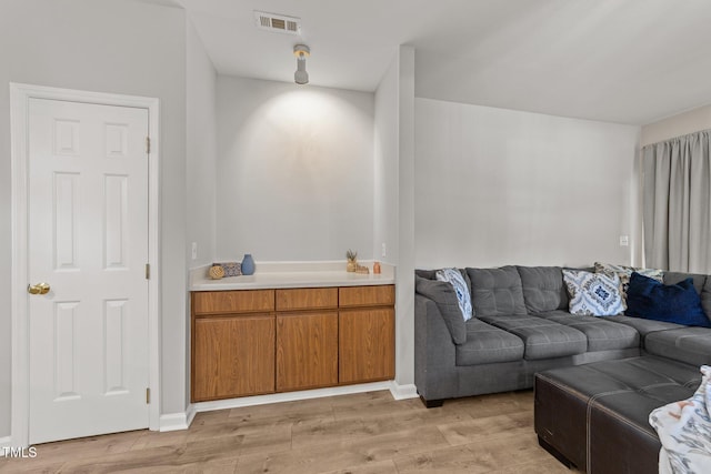 living room with light wood-type flooring and baseboards