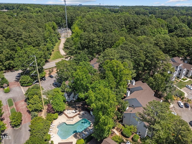 bird's eye view of a forest and a pool area