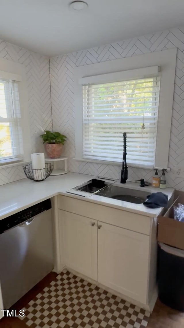 200 S Pettigrew St, Raleigh, NC 27610 - kitchen featuring dishwasher, light countertops, white cabinetry, decorative backsplash, and a sink