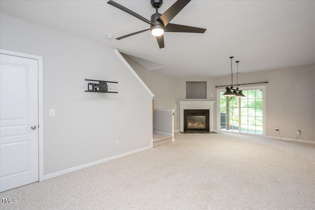 7616 Satinwing Ln, Raleigh, NC 27617 - unfurnished living room with carpet, baseboards, ceiling fan, and a fireplace with flush hearth