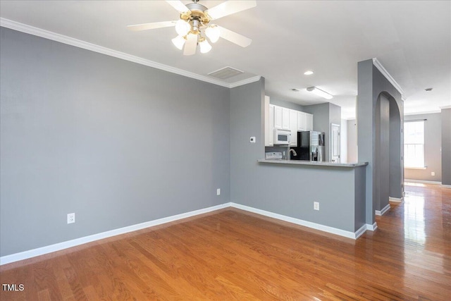 7616 Satinwing Ln, Raleigh, NC 27617 - kitchen featuring stainless steel fridge with ice dispenser, white microwave, crown molding, baseboards, and wood finished floors