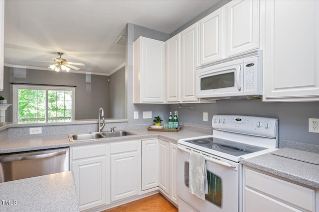 7616 Satinwing Ln, Raleigh, NC 27617 - kitchen with white appliances, a sink, crown molding, light countertops, and white cabinets