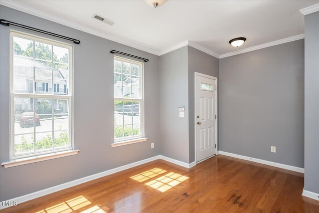 7616 Satinwing Ln, Raleigh, NC 27617 - entrance foyer with wood finished floors, baseboards, and crown molding