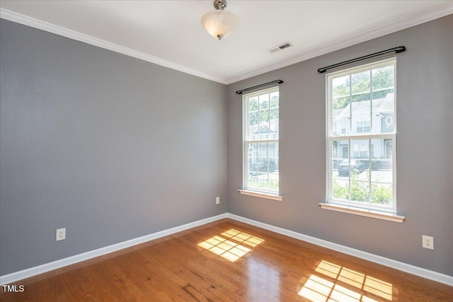 7616 Satinwing Ln, Raleigh, NC 27617 - unfurnished room featuring baseboards, ornamental molding, and wood finished floors