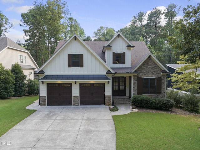 view of front facade featuring a garage, a front lawn, board and batten siding, and stone siding