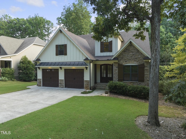 view of front of home with an attached garage, stone siding, and a front lawn
