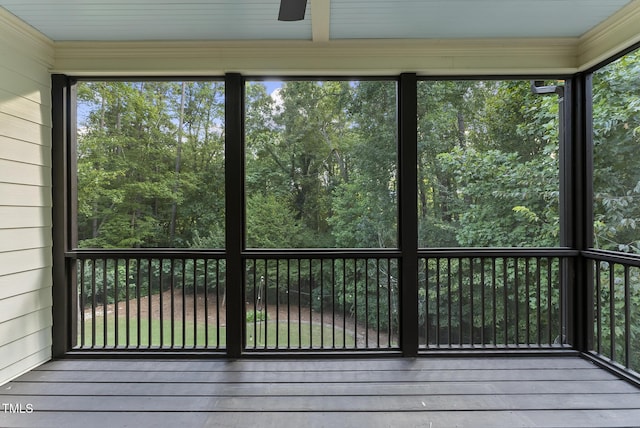 unfurnished sunroom with ceiling fan