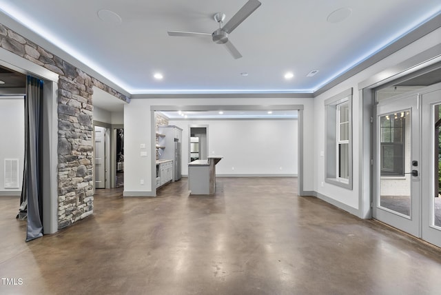 unfurnished living room featuring ceiling fan, concrete floors, french doors, baseboards, and visible vents