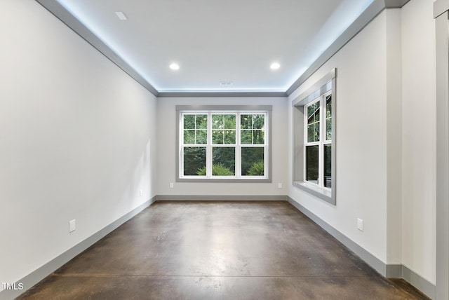 spare room with baseboards, recessed lighting, and finished concrete floors
