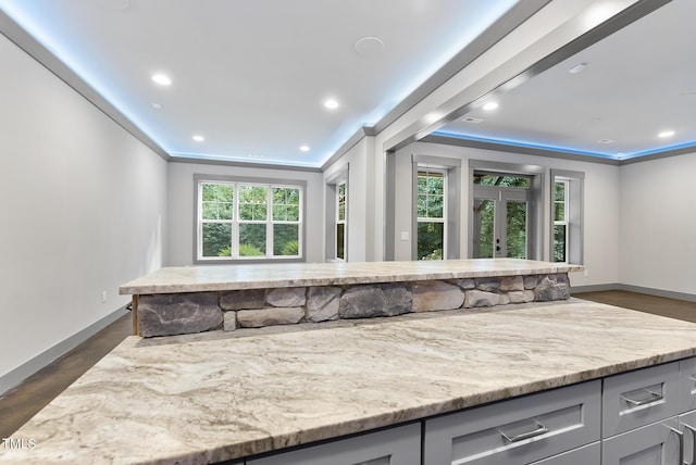 kitchen featuring baseboards, gray cabinetry, ornamental molding, and french doors