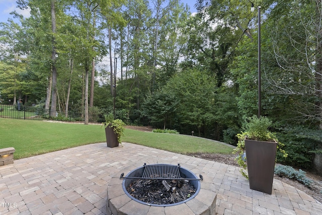 view of patio / terrace with fence and an outdoor fire pit