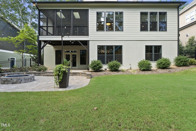 back of property featuring french doors, a lawn, fence, an outdoor fire pit, and a patio