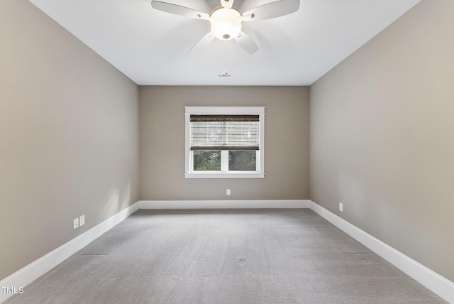 unfurnished room featuring a ceiling fan, baseboards, and carpet