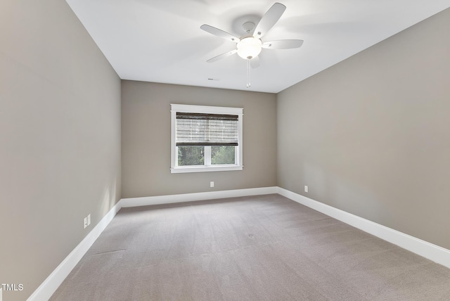 empty room featuring baseboards, carpet, and a ceiling fan