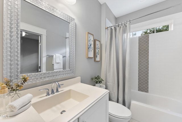 full bathroom featuring vanity, toilet, and shower / tub combo